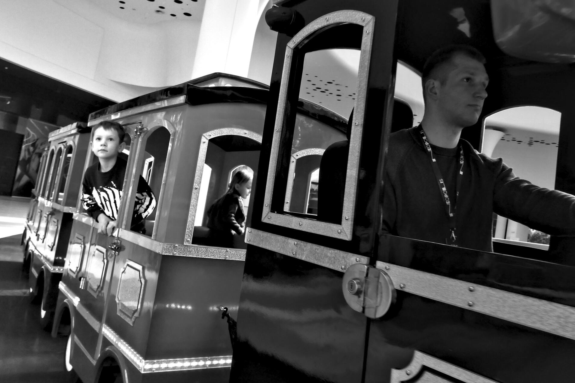 Kids riding a mall train. Kyiv, Ukraine, March 2025. Shot on Panasonic GX800.