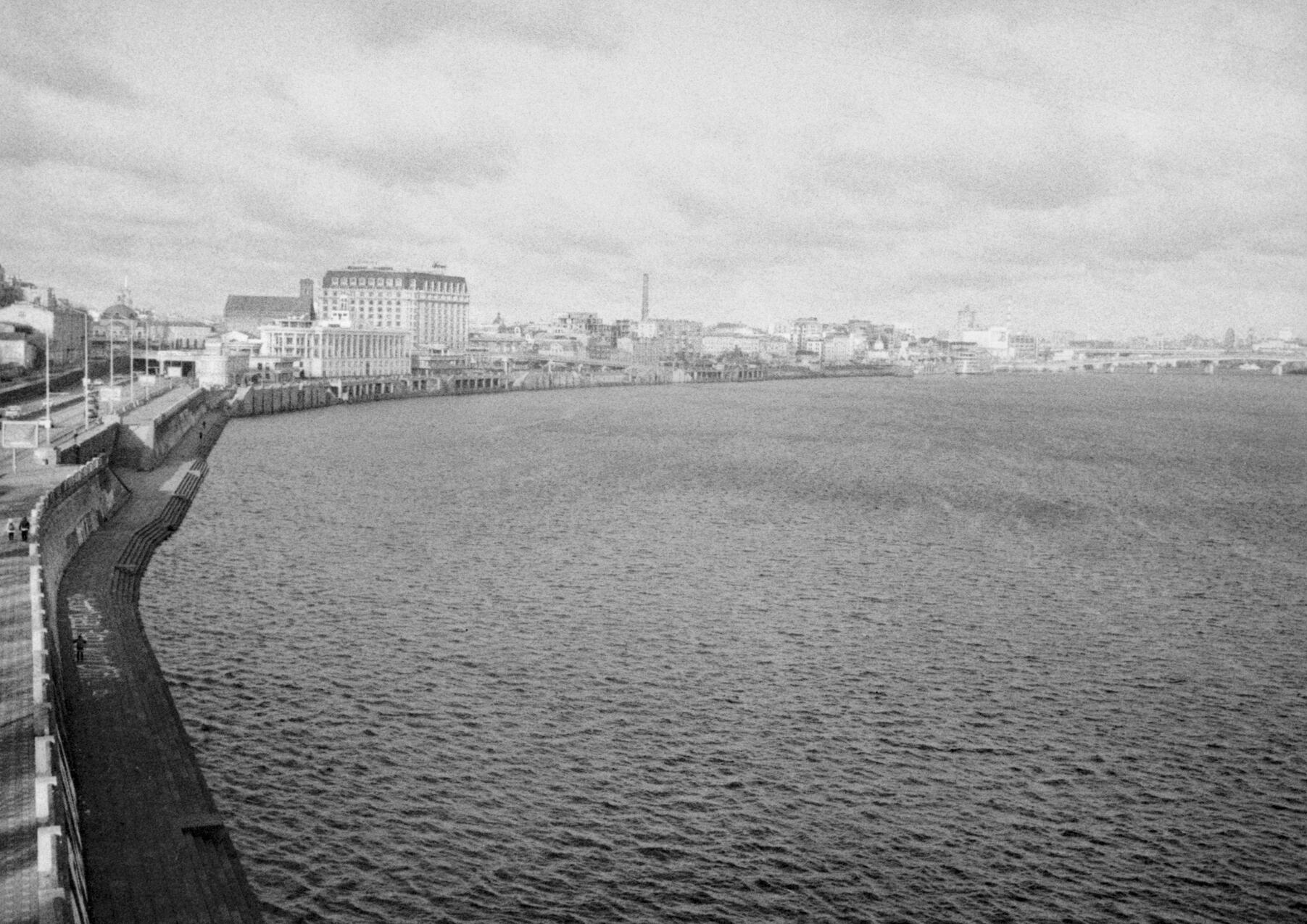 Winter clouds rolling over the Dnipro River, with Kyiv’s right bank in the distance. Shot from the Park Bridge, looking north. Kyiv, Ukraine, January 2025. Shot on Chaika 2m, Ilford Delta 400.